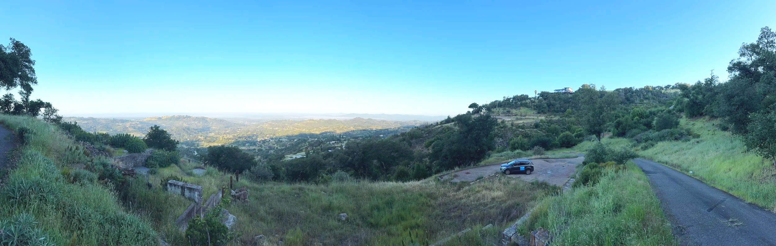 Panorama of a valley taken from a hillside at sunrise