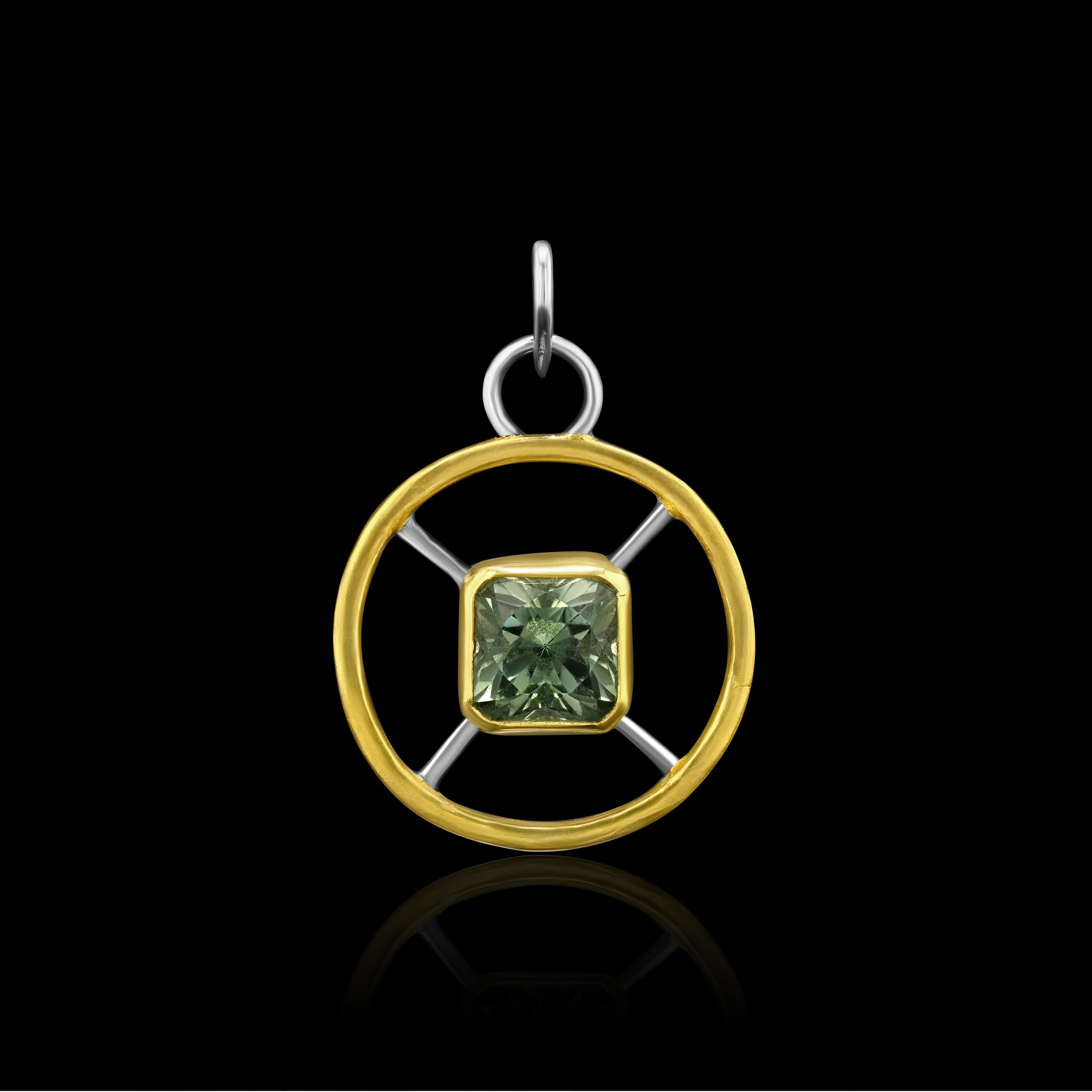 round pendant with afaceted prasiolite quartz set 22k gold in the middle, sterling silver spokes, and a 24k keum boo outer ring