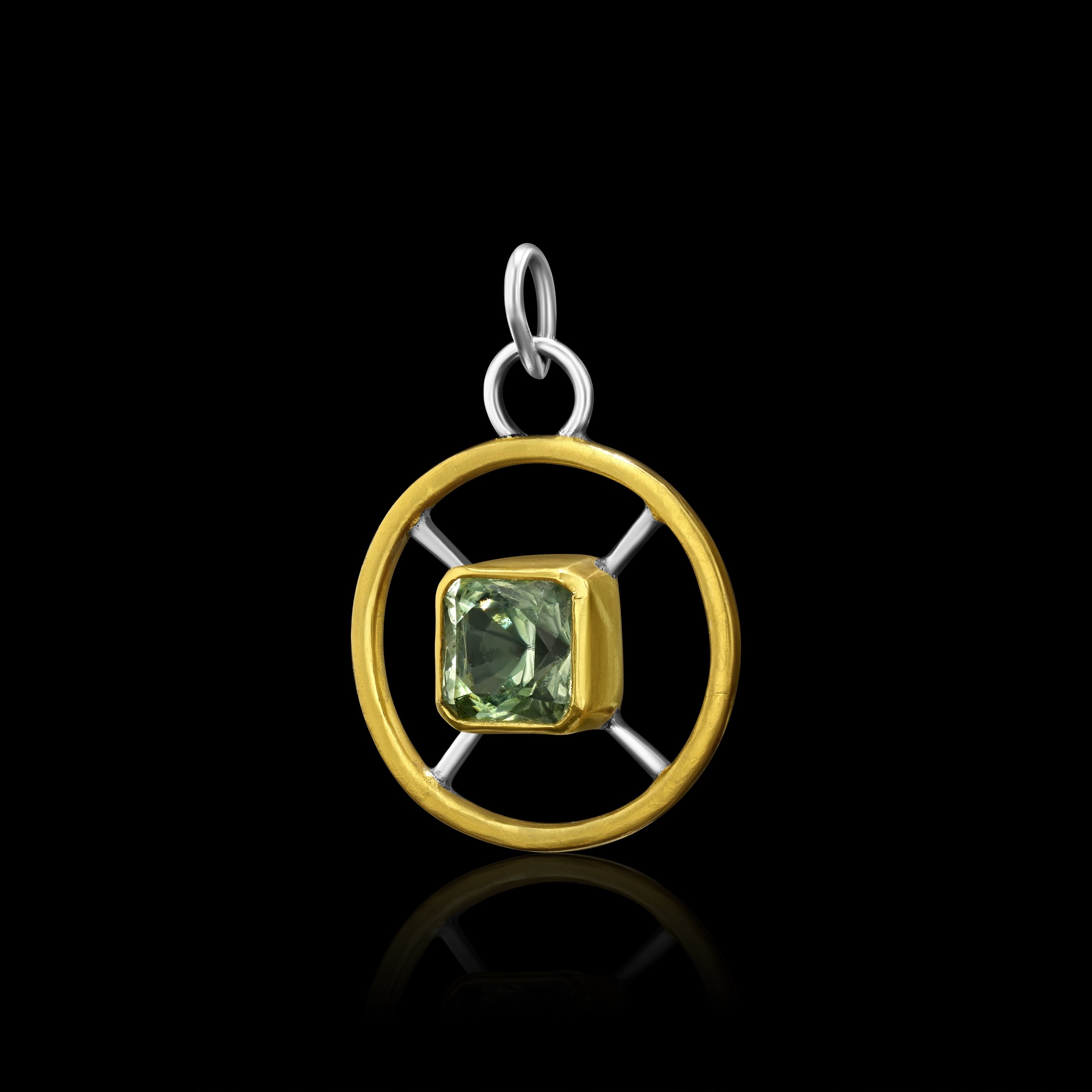 side view of a round pendant with afaceted prasiolite quartz set 22k gold in the middle, sterling silver spokes, and a 24k keum boo outer ring
