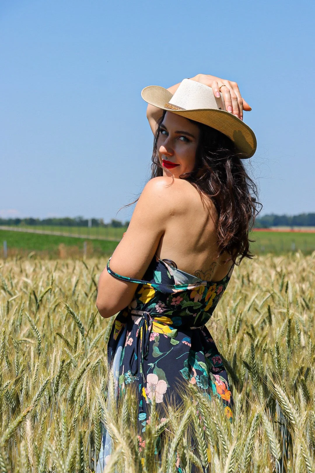 Valerie Sky | Your Unconventional Lover | Valerie in a floral dress and white hat, bare shoulder, looking at camera cutely.JPG