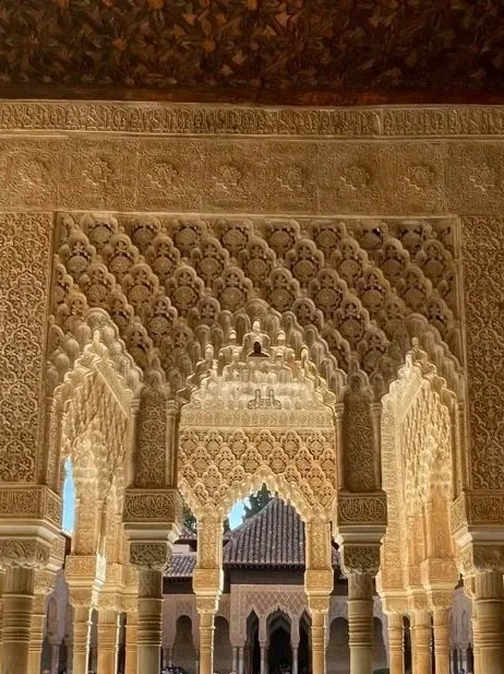 Intricate Islamic architectural archways and ceiling details in a historical building.