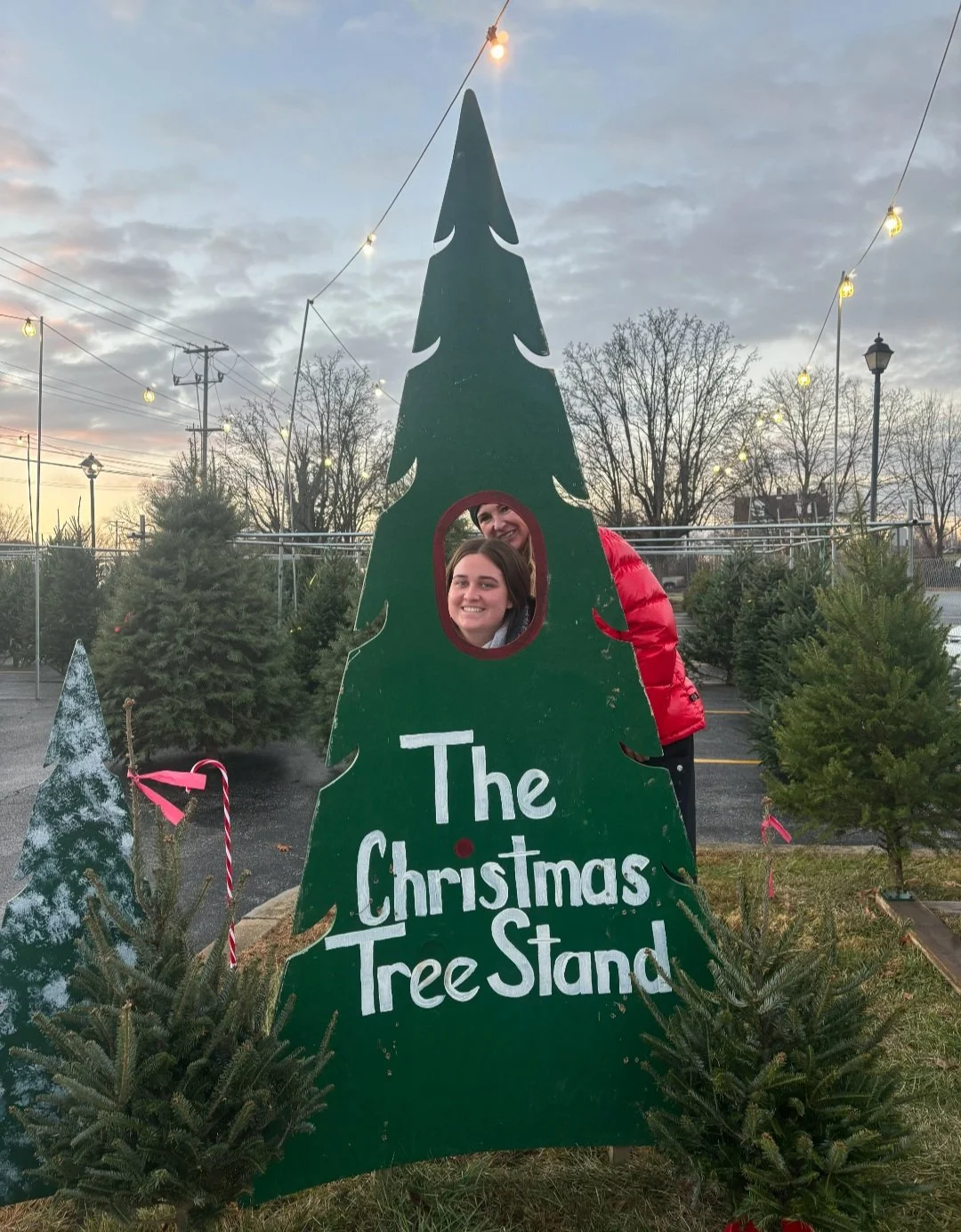 A warehouse aisle filled with stacked cardboard boxes wrapped in clear plastic, stored on pallets along the sides and in the middle.