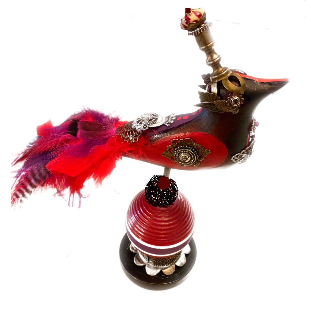 MY FEATHERED FRIEND / 2022/
Mixed Media/
10" x 7"/
Materials: carved wood, canning lid, tin, croquet ball, finial, marble, paint, feathers, shoe buckle, and watch parts.
An old croquet ball inspired this steampunk bird.