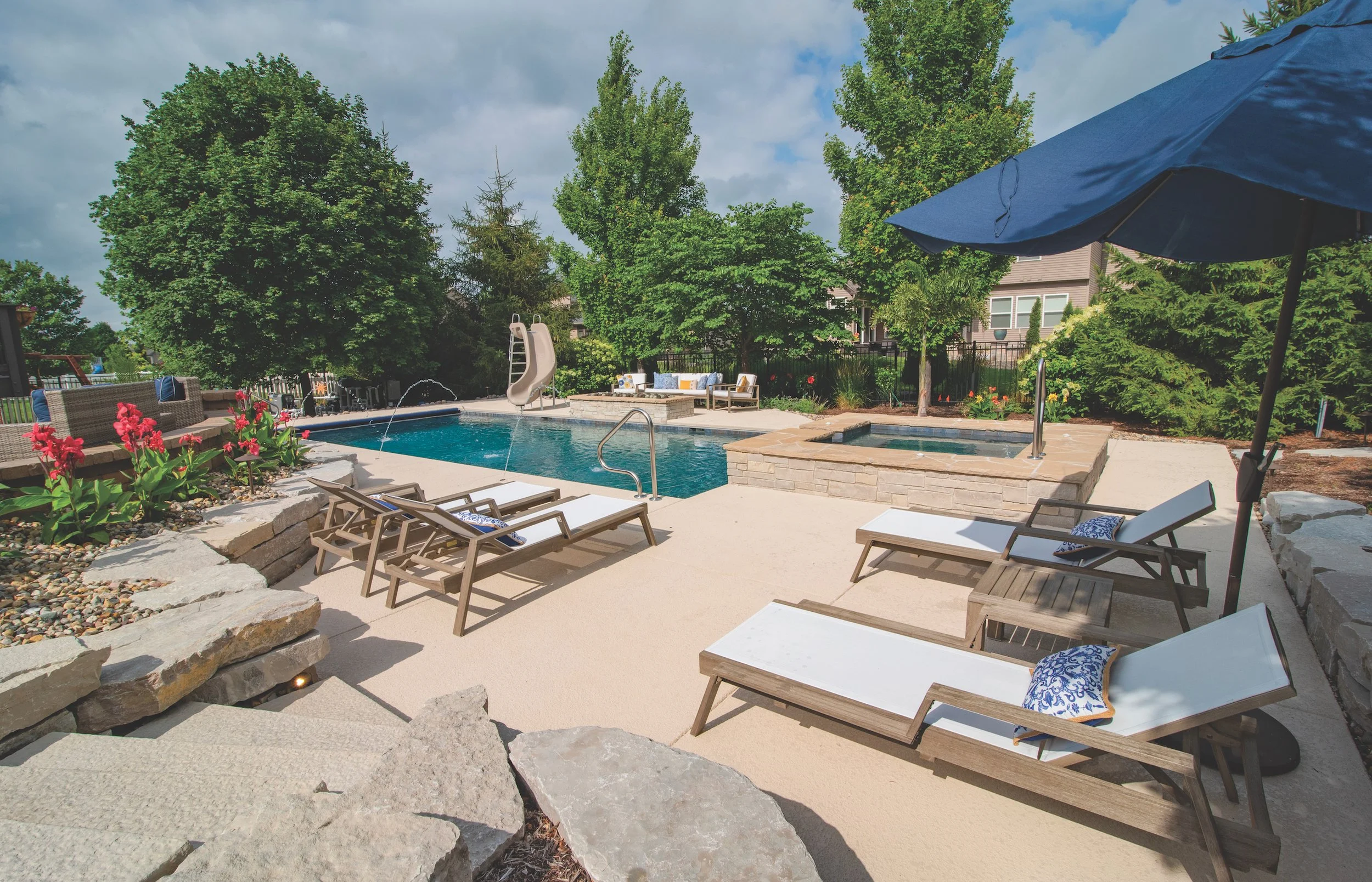 Barrington Pools built classic pool with slide and spa outdoor living area and fire features