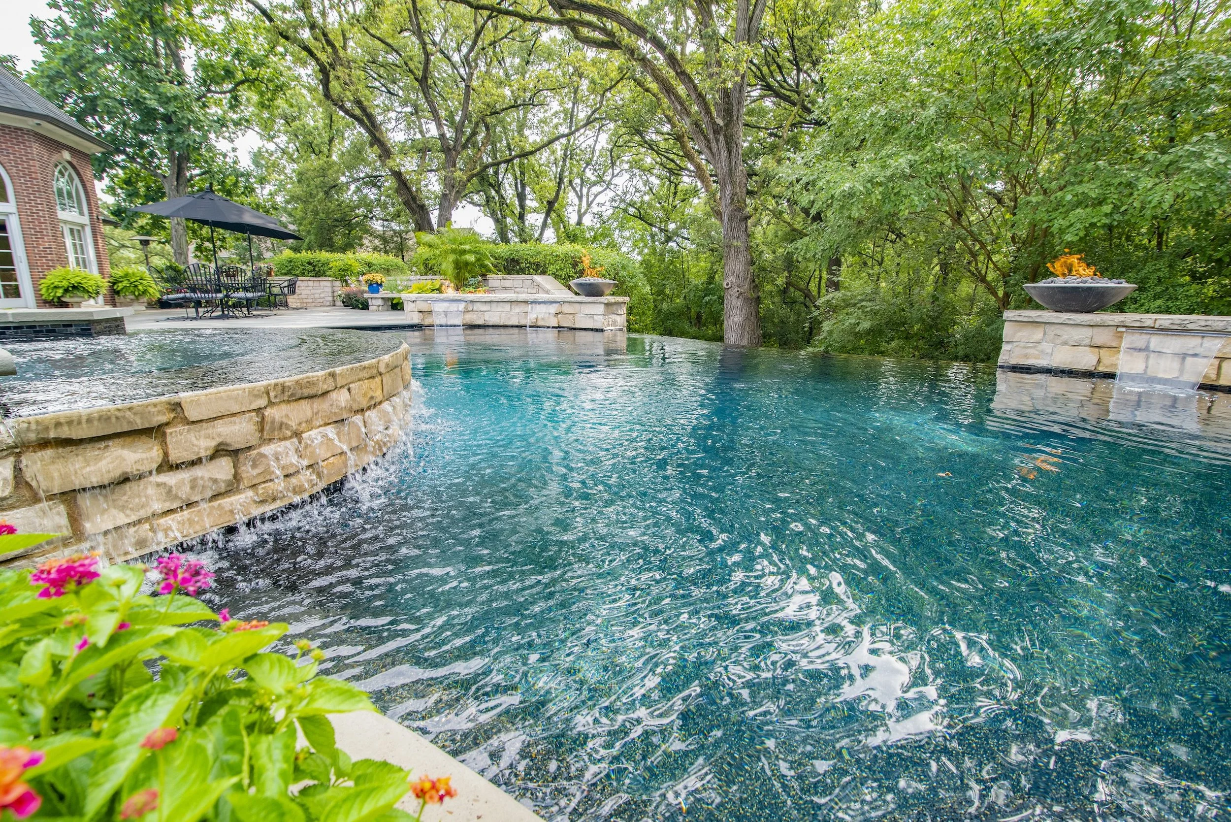 Beautiful natural pool built by Barrington Pools infinity edge spa, water features, fire bowls