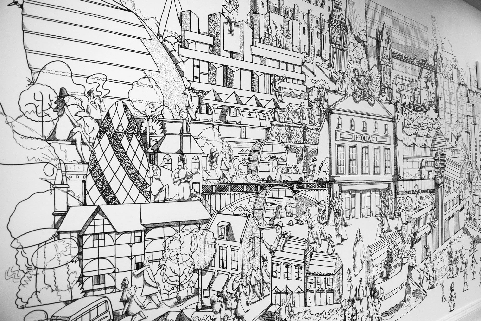 Hand-painted large-scale mural installation by Chris Martin illustrator – black ink drawing of London cityscape featuring The Old Vic Theatre, London Eye, Tower of London, Big Ben and street characters, installed in The Old Vic Theatre bar London