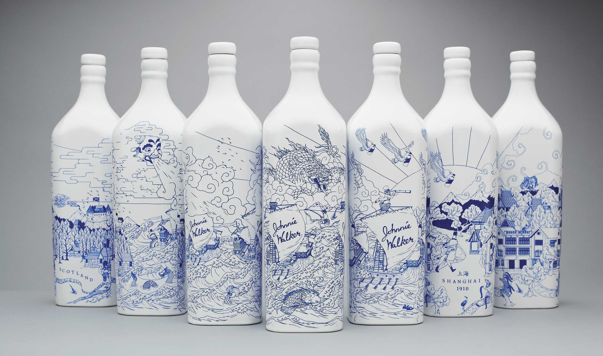 Full collection of illustrated Johnnie Walker porcelain bottles by Chris Martin – blue and white china-style whisky bottles featuring Scotland and Shanghai 1910 scenes with dragons, ships and the Striding Man, limited edition packaging for Diageo