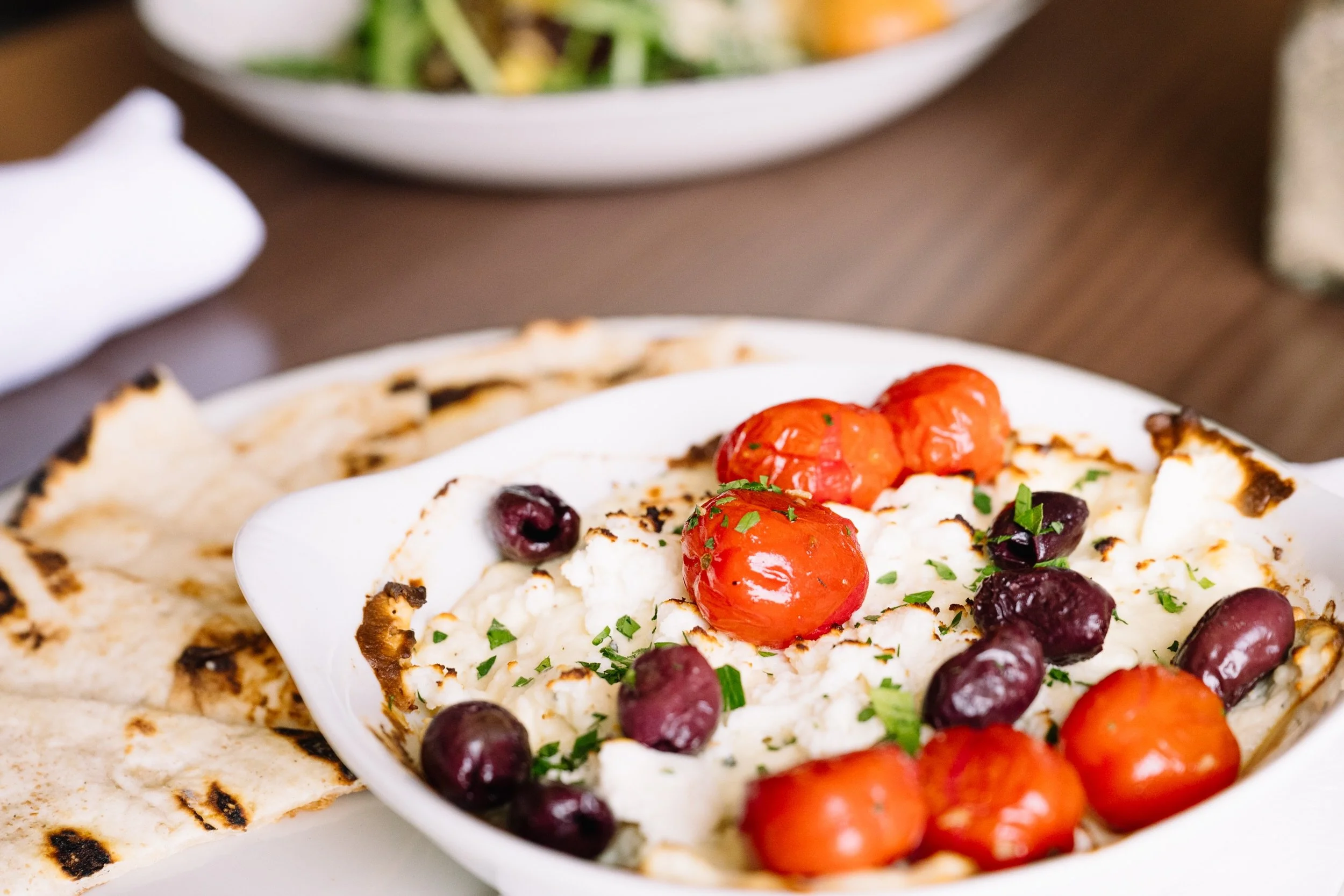 🫒... baked feta finished with garlic-roasted cherry tomatoes, kalamata olives, olive oil, and herbs, served with warm grilled pita points. One of those appetizers that disappears quickly once it hits the table.

#lookoutpointcc
