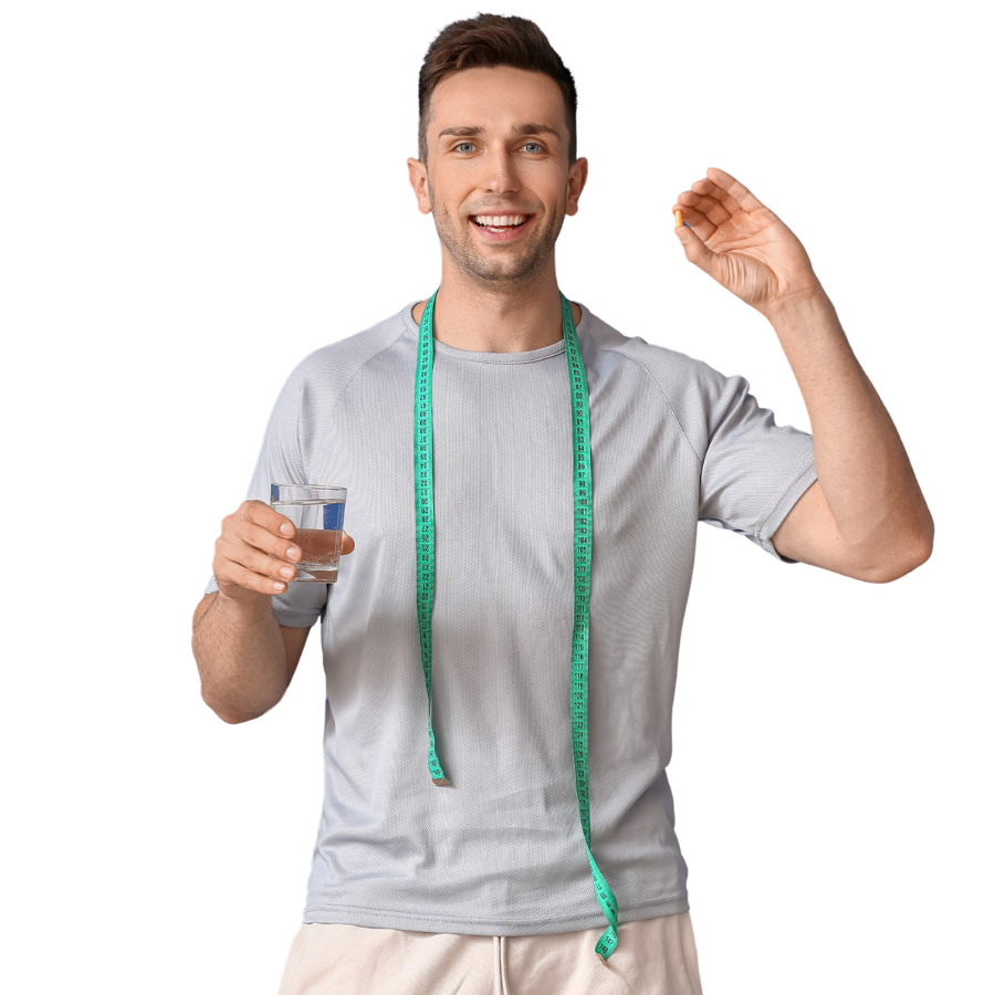 A smiling man holding a glass of water with a tape measure around his neck, showing he is a health or fitness enthusiast.