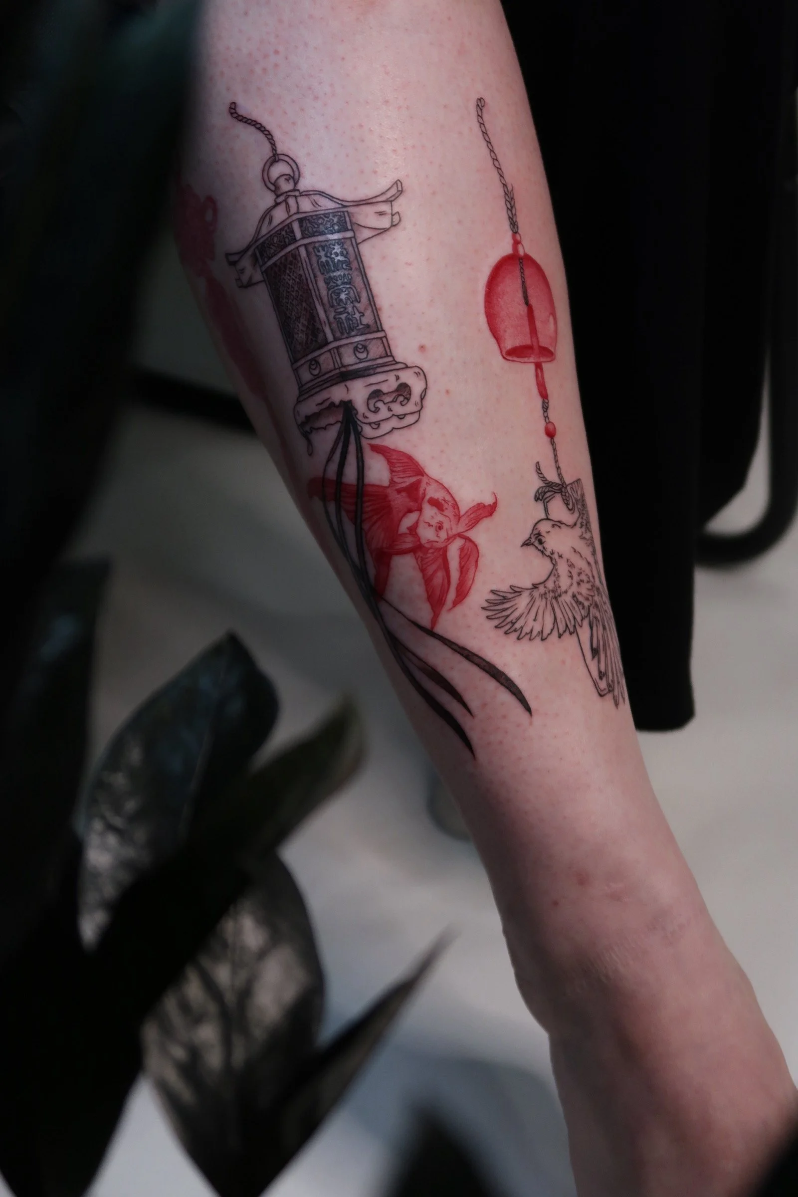 Japanese lantern tattoo with fish and wind chime with bird.