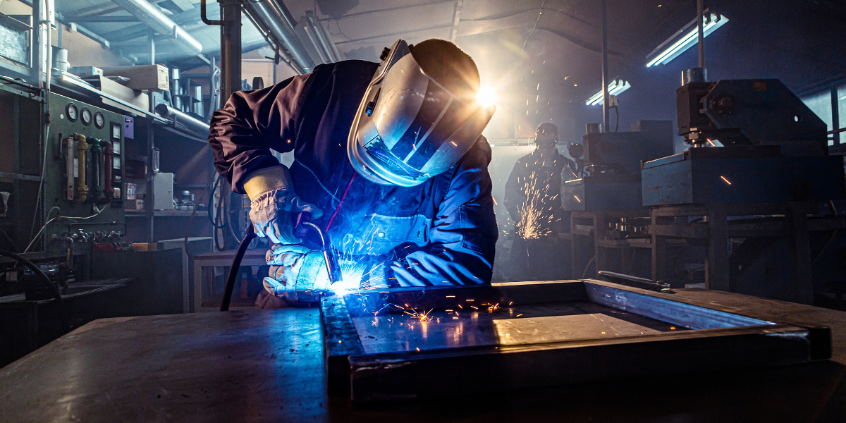 Professional welder working in metal shop