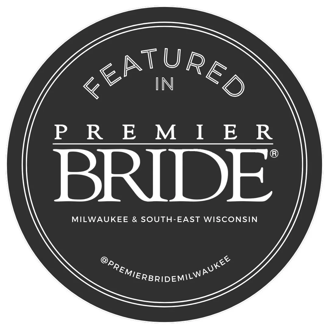 Black circular badge with white text that reads: "Featured in Premier Bride Milwaukee & South-East Wisconsin @premierbridemilwaukee".