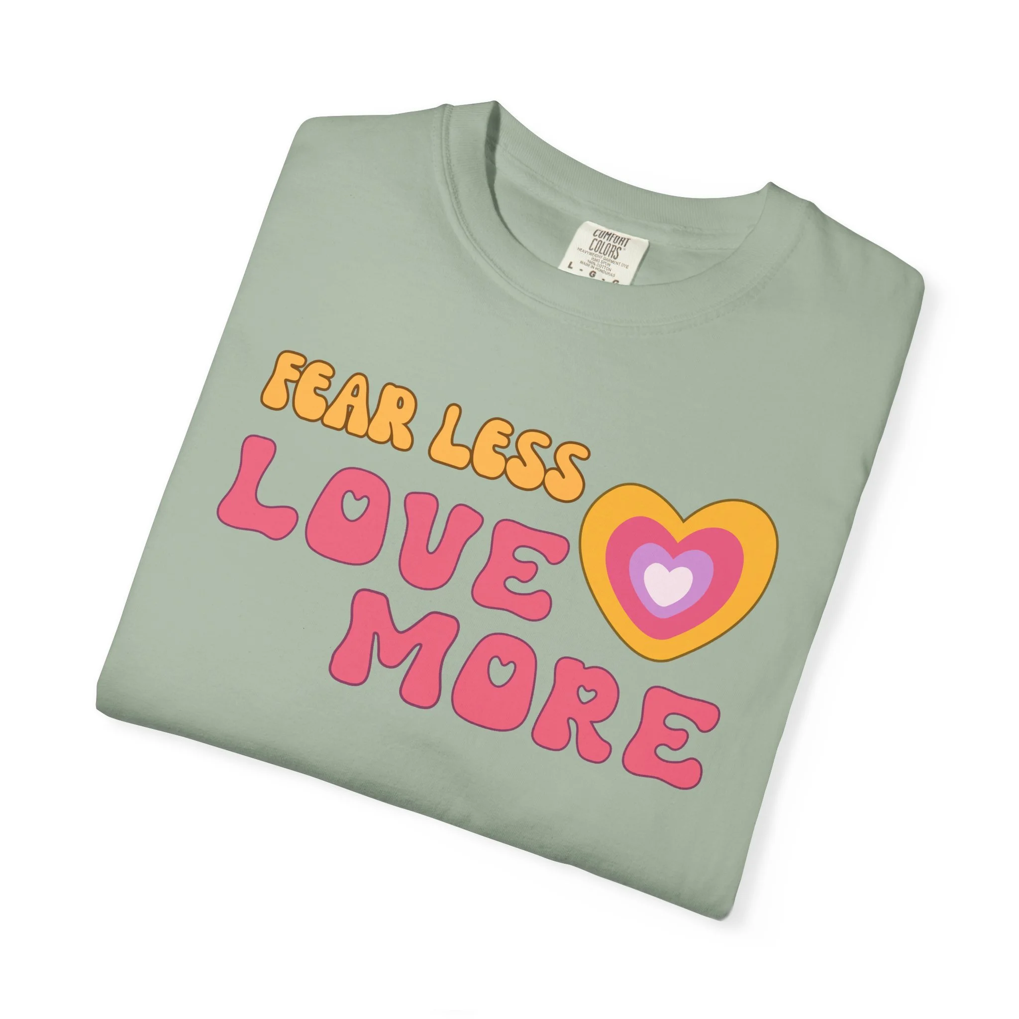 Comfort colors graphic T-shirt with retro font that says live more fearless and graphic of retro style heart