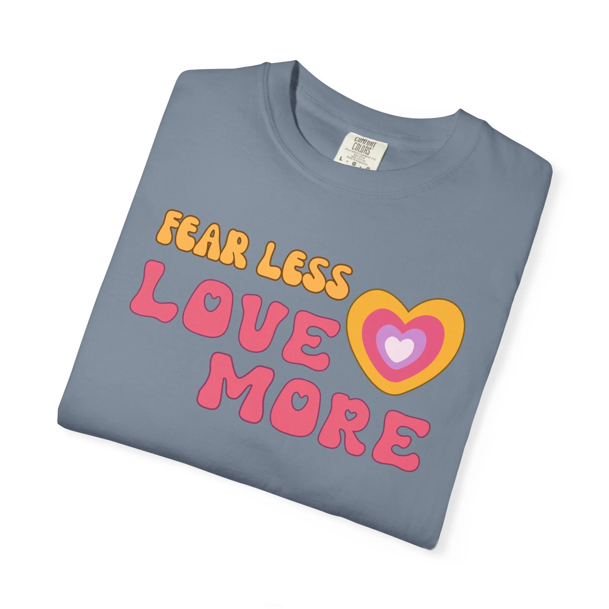 Comfort colors graphic T-shirt with retro font that says live more fearless and graphic of retro style heart