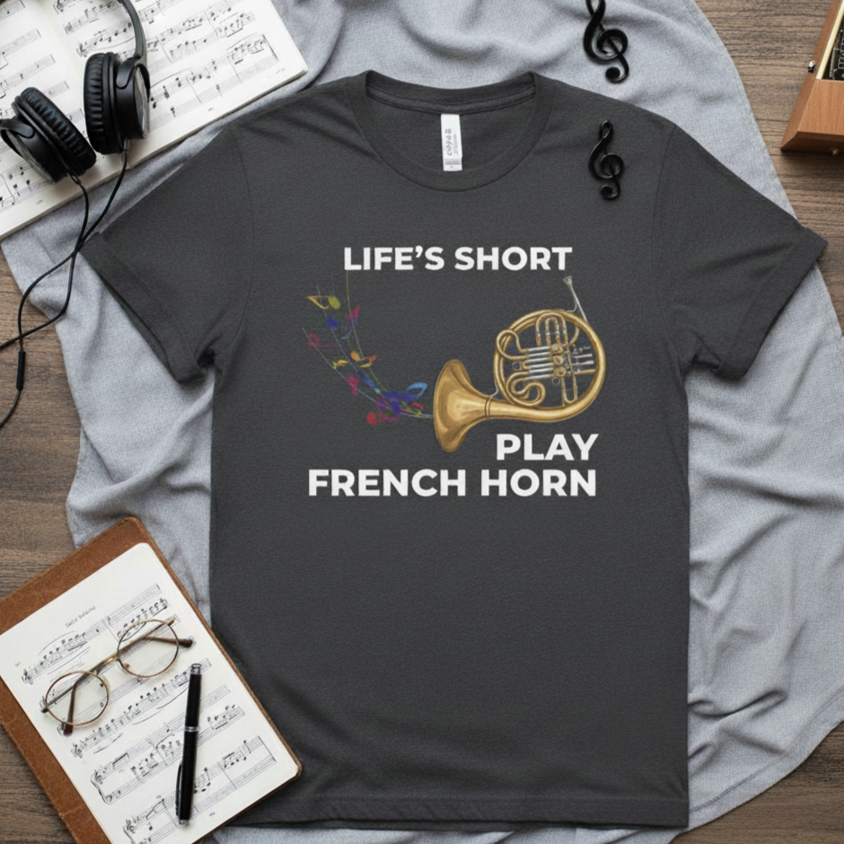graphic tee with image of a french horn, colorful music notes, and text that says life's short play french horn
