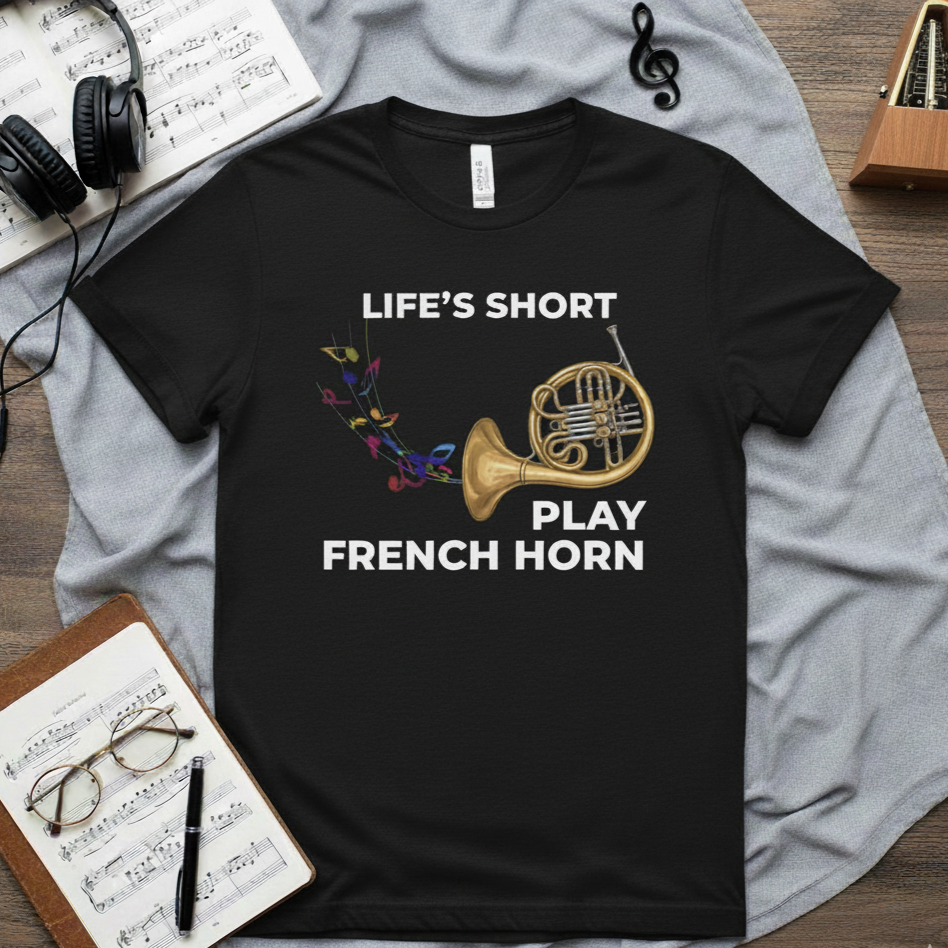 graphic tee with image of a french horn, colorful music notes, and text that says life's short play french horn