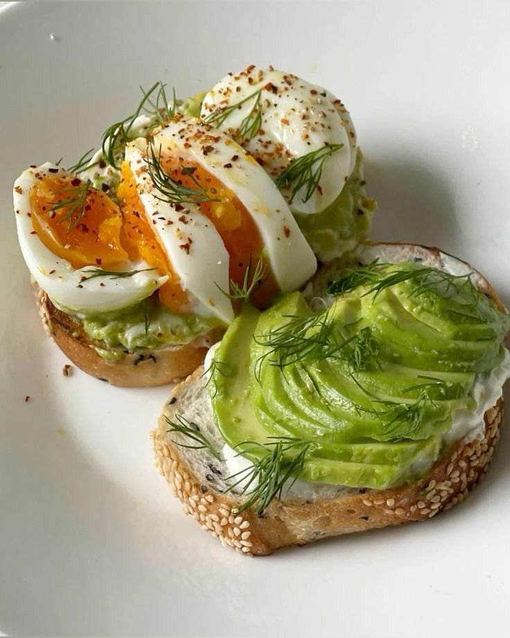Avocado toast with sliced boiled eggs and dill on crusty bread