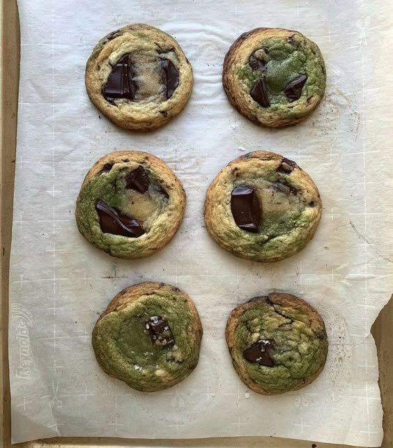 Six matcha chocolate chip cookies on parchment paper