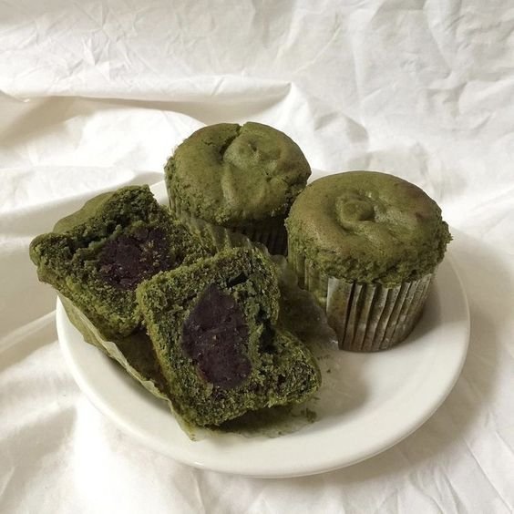 Green muffins with fillings on a white plate