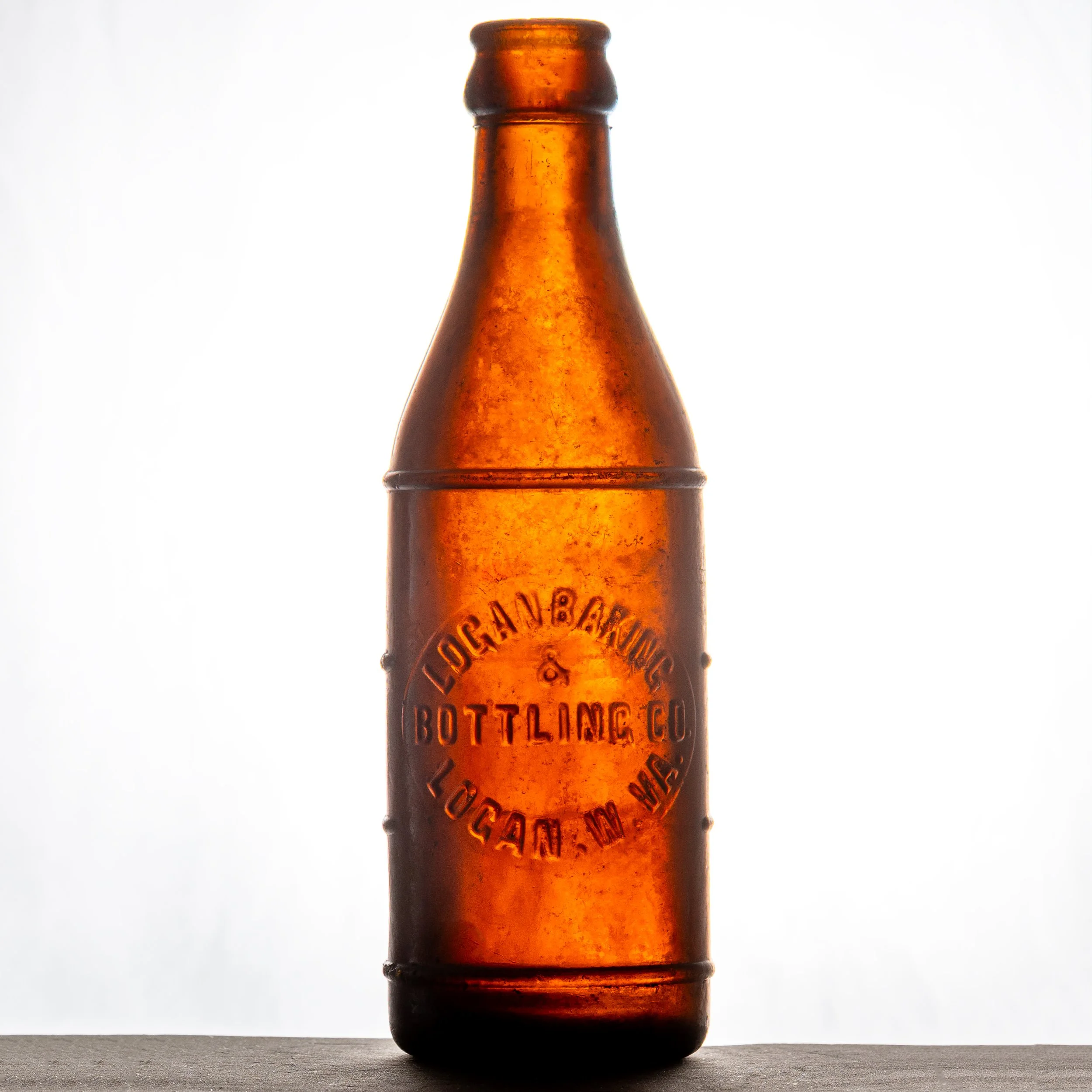 Logan Baking & Bottling Co., Gay-Ola, Logan soda bottle. ABM, amber glass, Gay-Ola mold. Front.