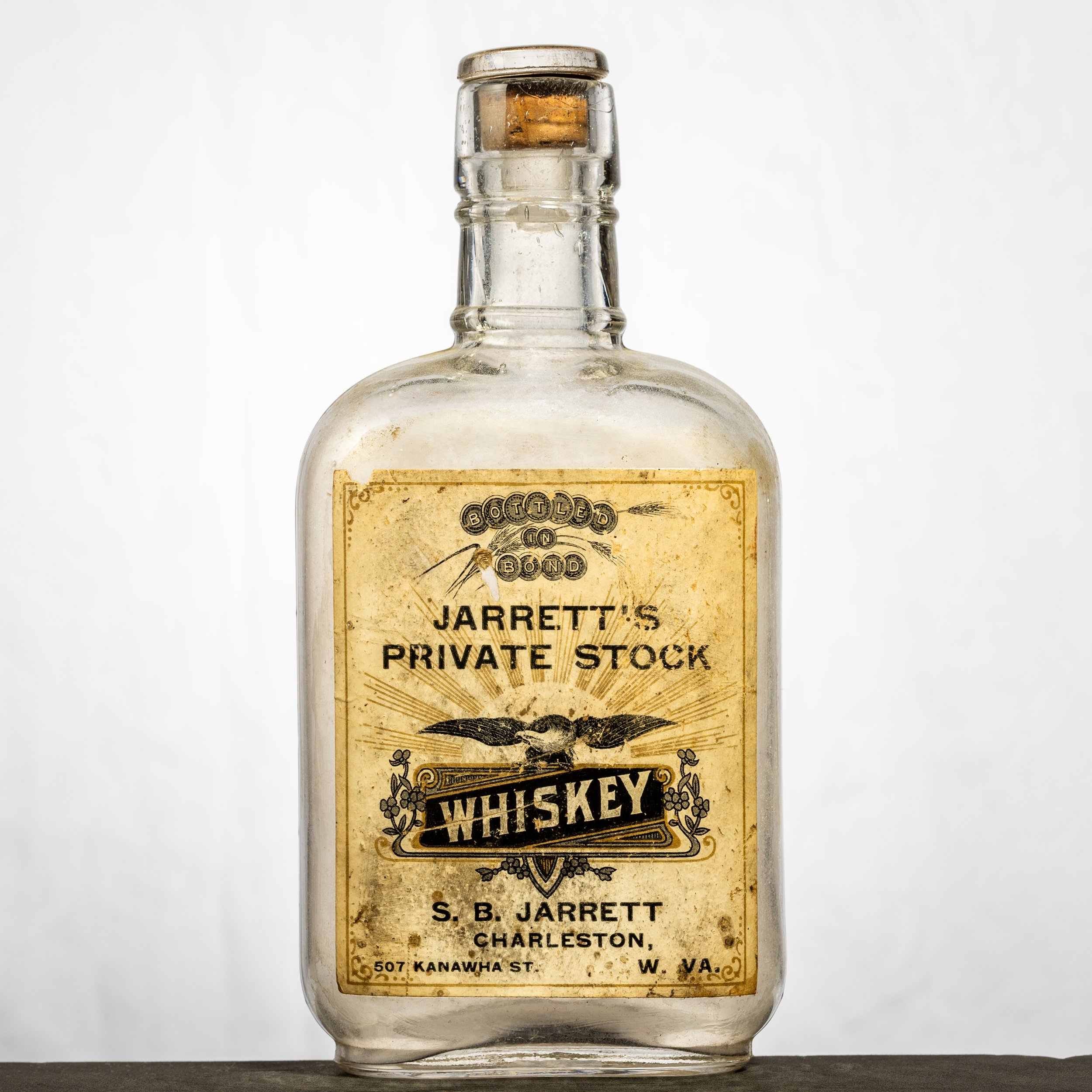 S.B. Jarrett, Jarrett's Private Stock Whiskey, Charleston labeled whiskey bottle. Half-pint, eagle flask.