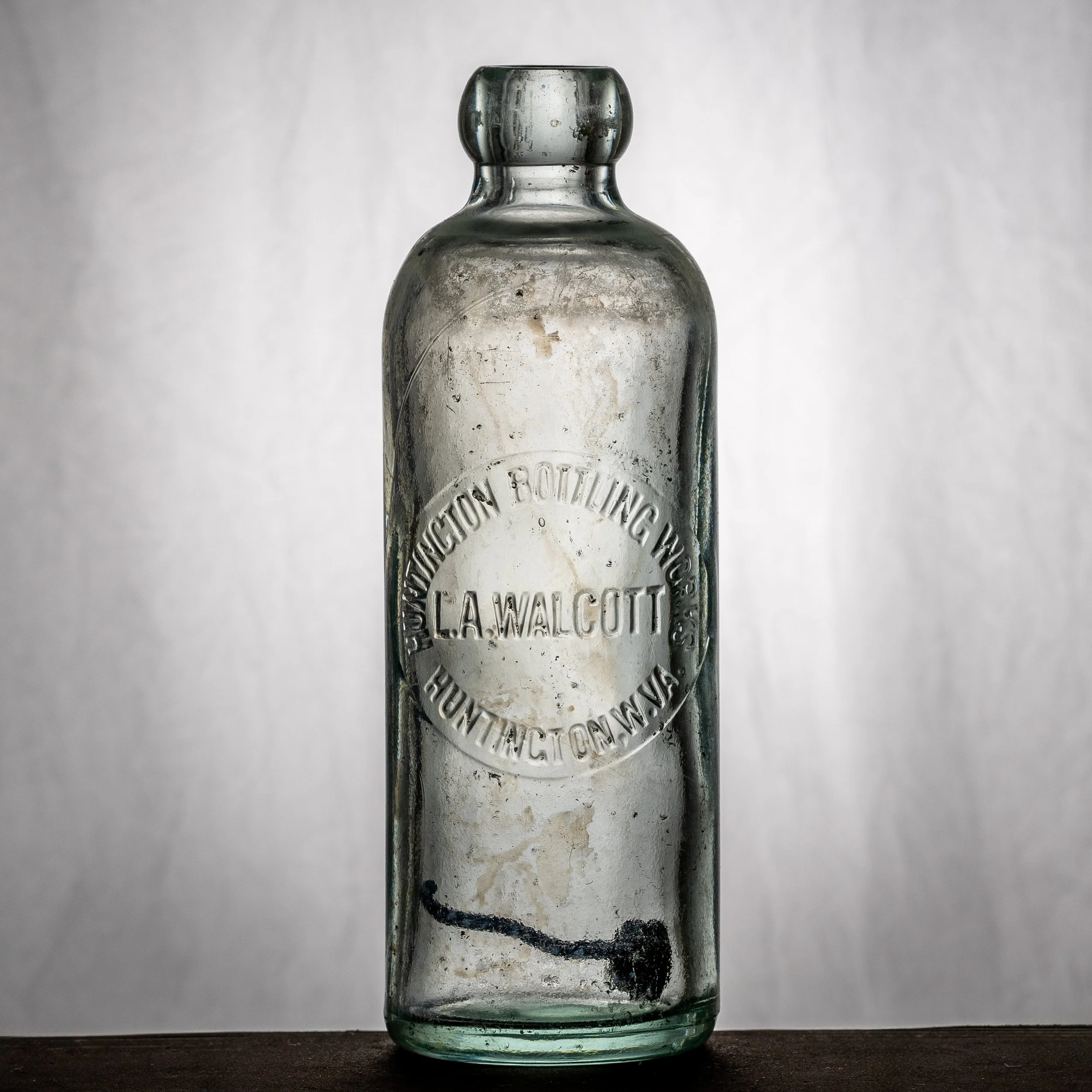 Huntington Bottling Works, L.A. Wolcott, Huntington hutchinson-style soda bottle. Error bottle--spelled Wolcott with an A.