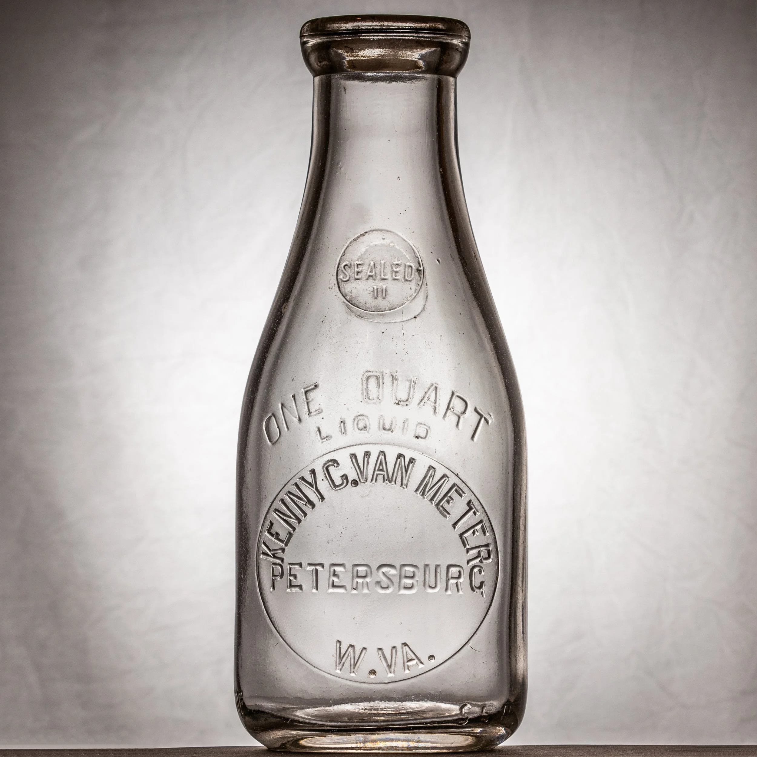 Kenny C. Van Meter (misspelled), Petersburg milk bottle. Quart, round, embossed.