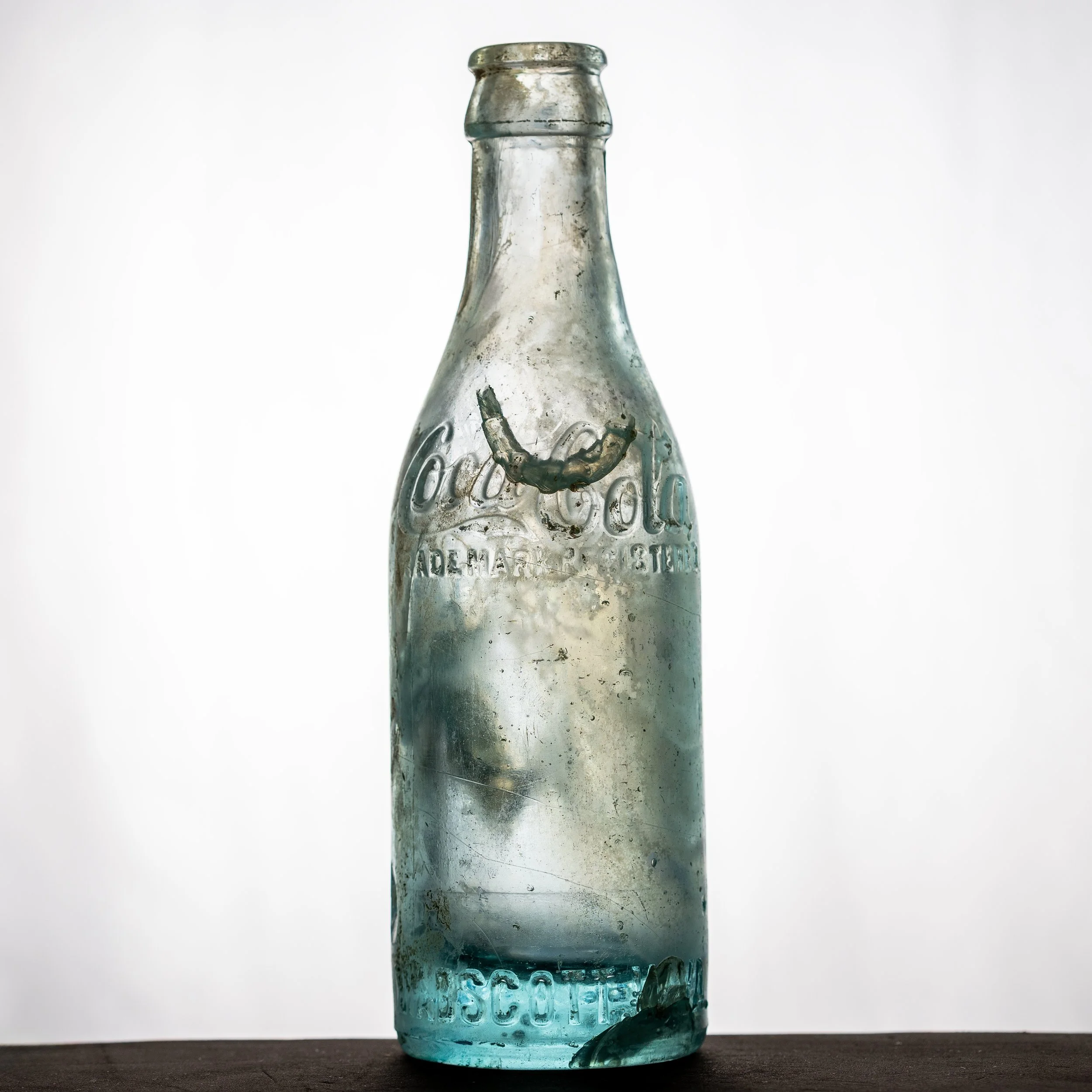 Coca-Cola Bottling Co., Mabscott straight sided Coke bottle. Shoulder-script, aqua blue glass. Front.