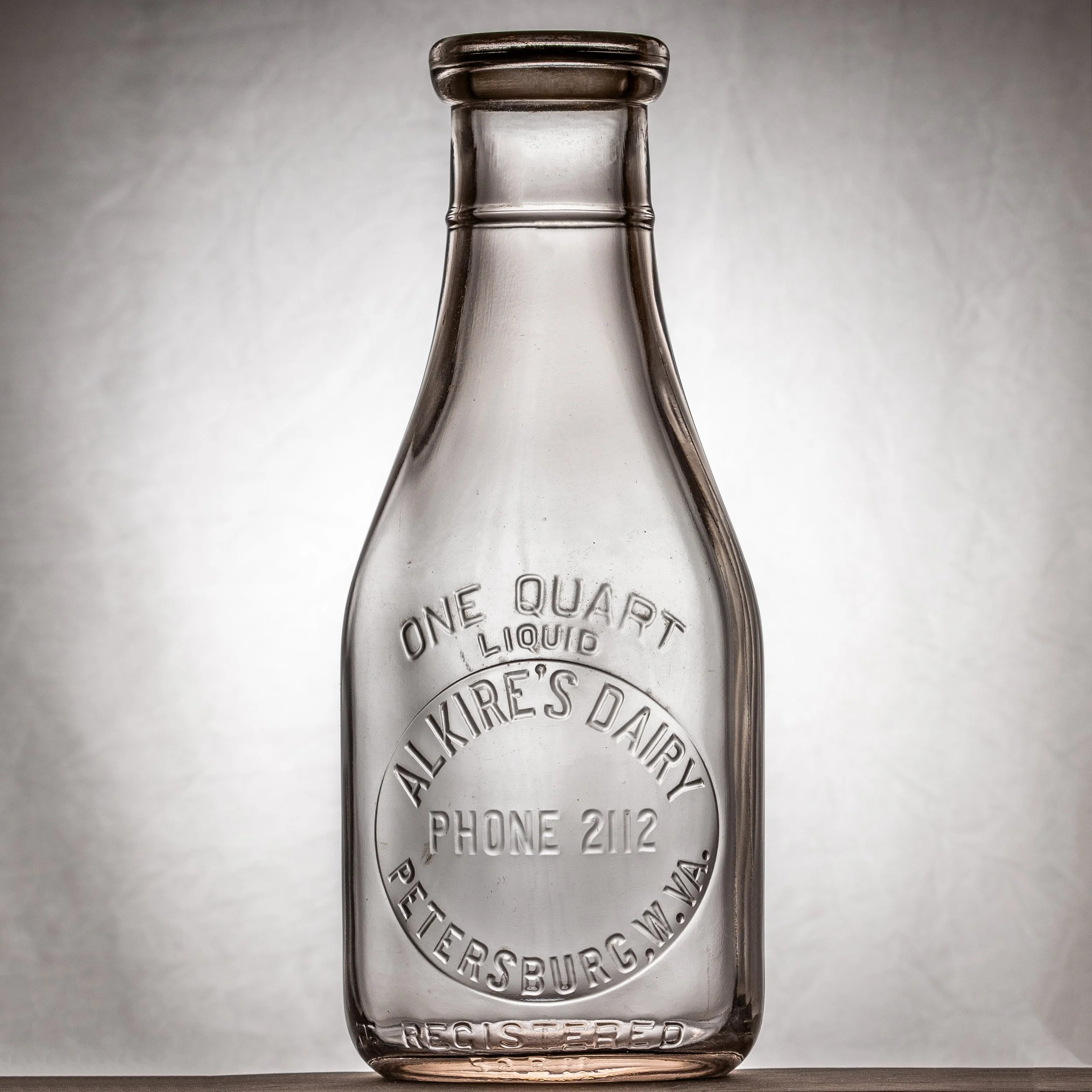 Alkire's Dairy, Petersburg milk bottle. Quart, round, embossed, w/ ring around neck.