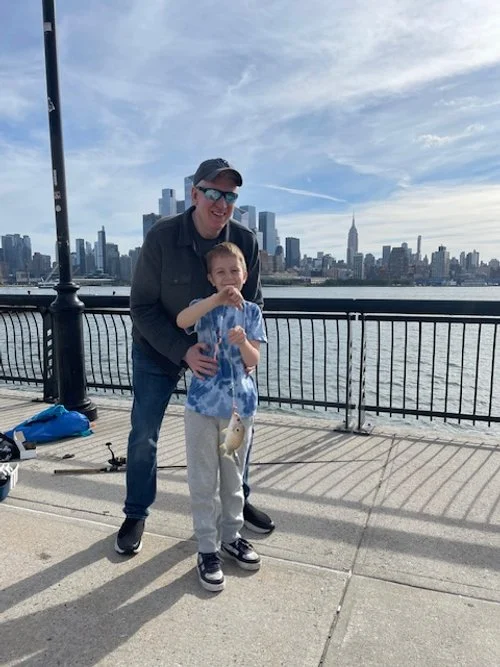 father and son catching fish in nyc