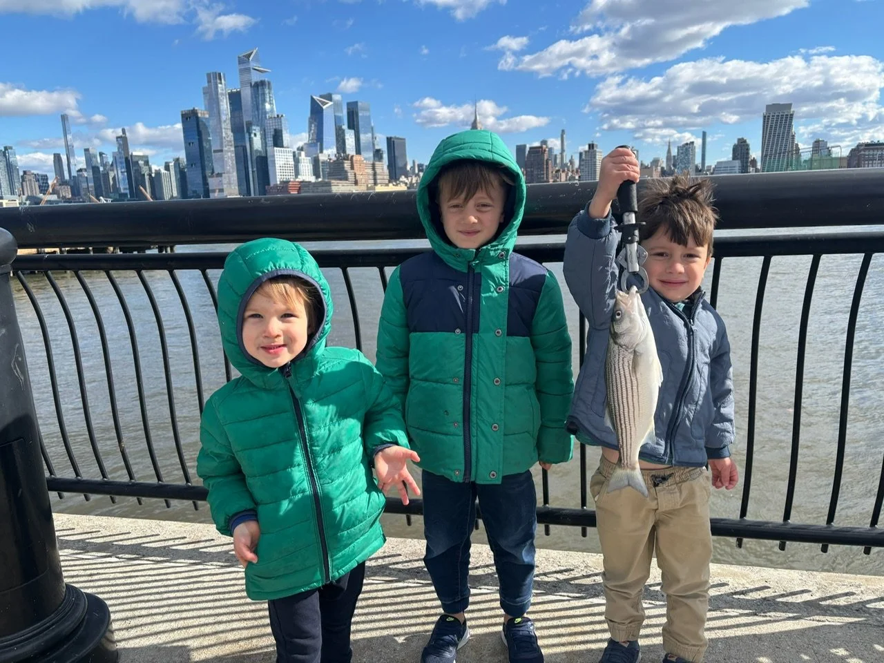 kids catching striped bass in the hudson river 