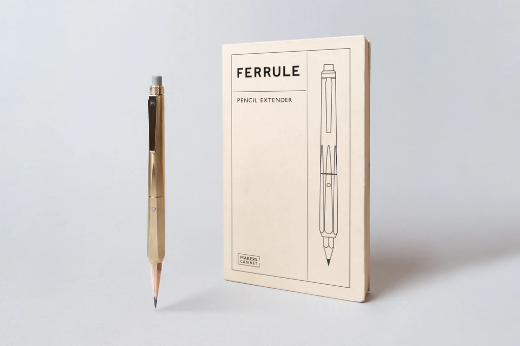 Pencil extender with packaging. The extender is gold-colored with a black clip and eraser. The packaging is beige with an illustration of the extender.