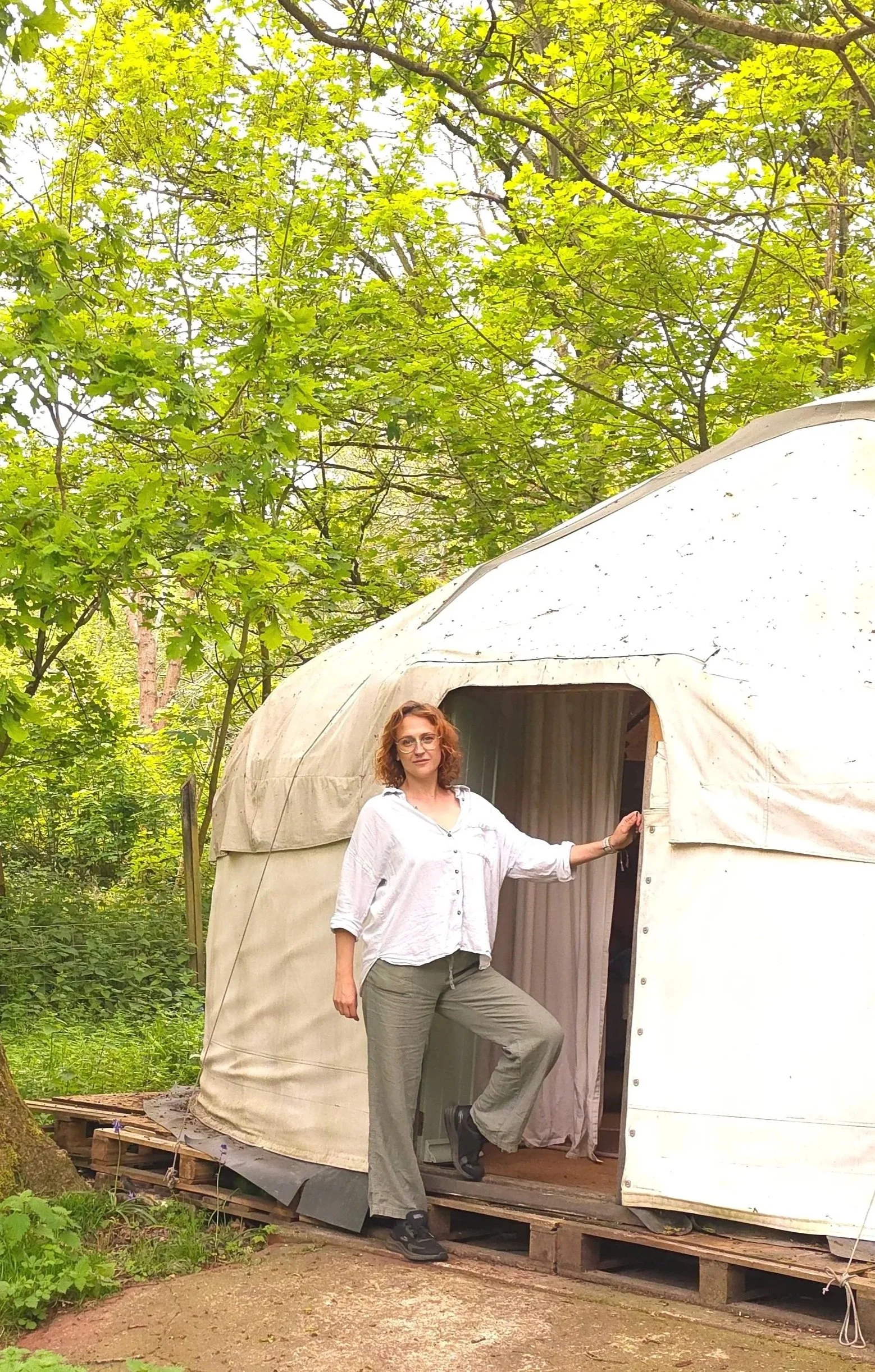 Root to Heal woodland wellness and healing space in Suffolk, Holistic therapist standing outside woodland healing yurt