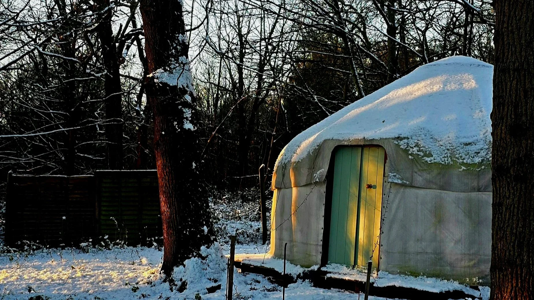 Yurt set in snowy, snow weather woodland, ready for somatic therapy, trauma informed healing, shadow work, self reflection and discovery, trauma release, emotional release, natural healing,