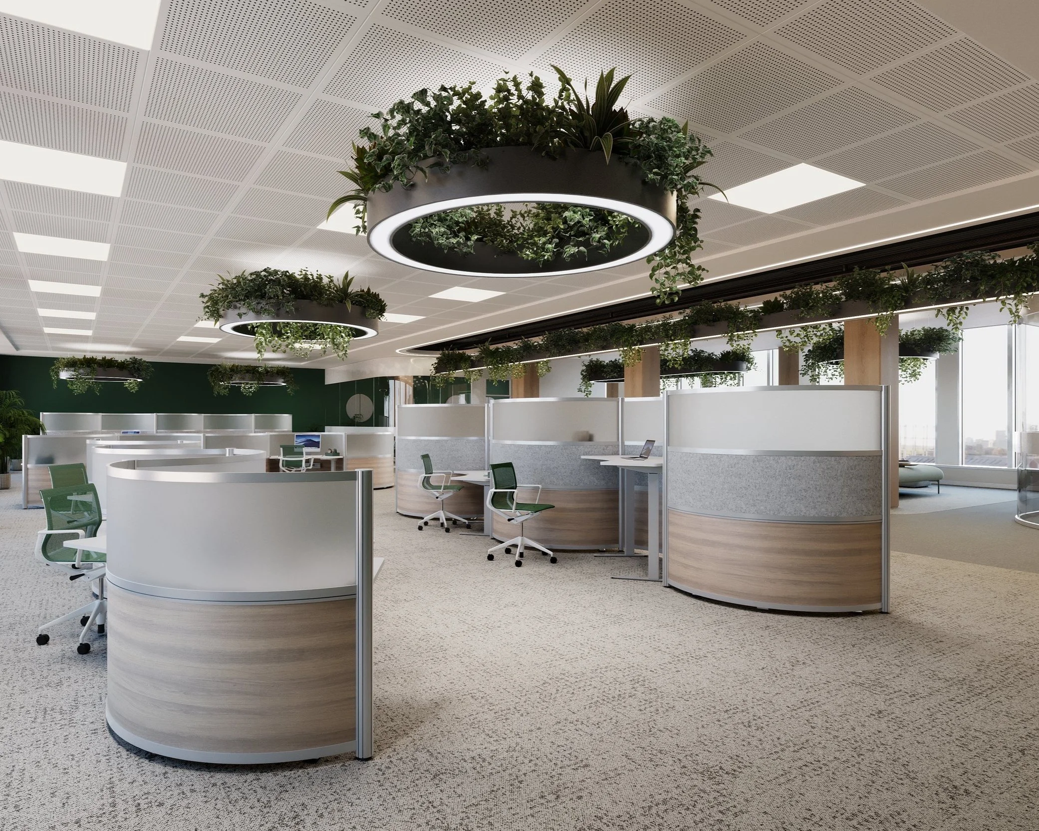 Modern office space with round white workstations, green chairs, hanging circular planters with lush green plants, and large windows providing natural light.