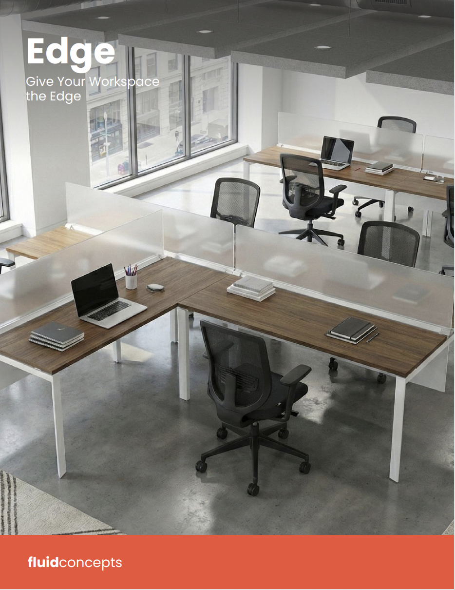 Modern office workspace with wooden desks, black mesh office chairs, computers, notebooks, and large windows letting in natural light.