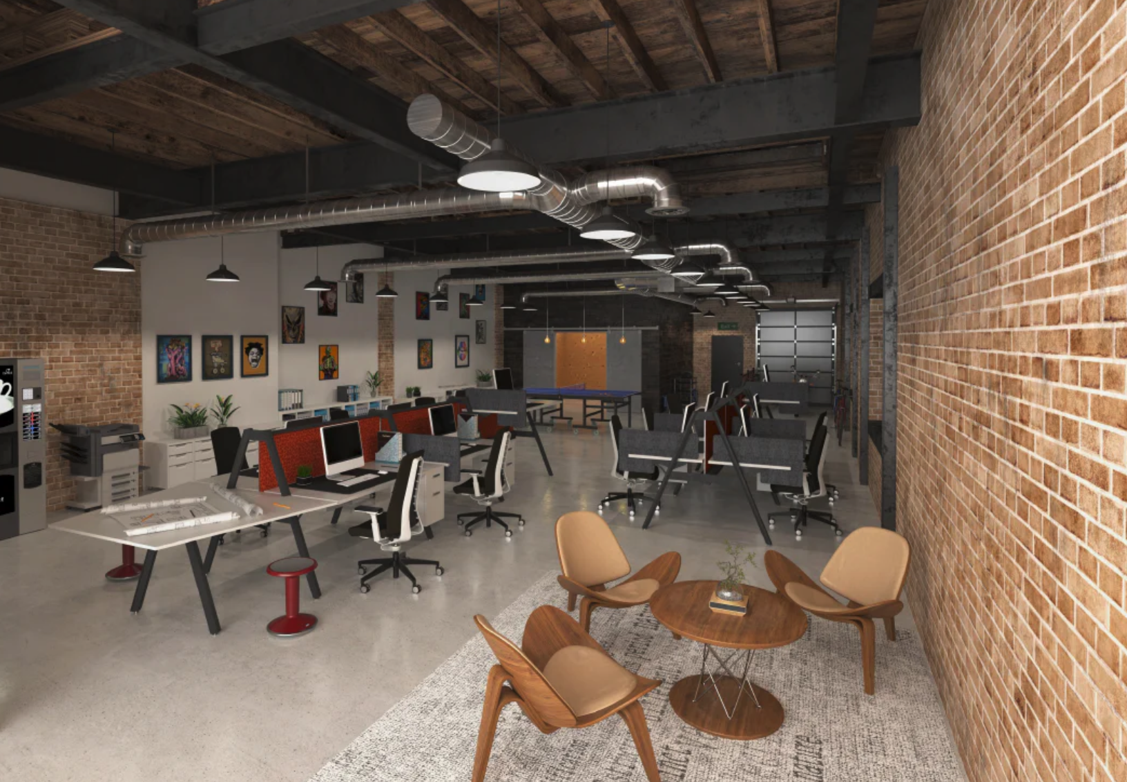 Open-plan modern office with brick walls, exposed ceiling beams, air ducts, a row of work desks with computers, a seating area with wooden chairs and a round table, and decor including framed artwork on the walls.