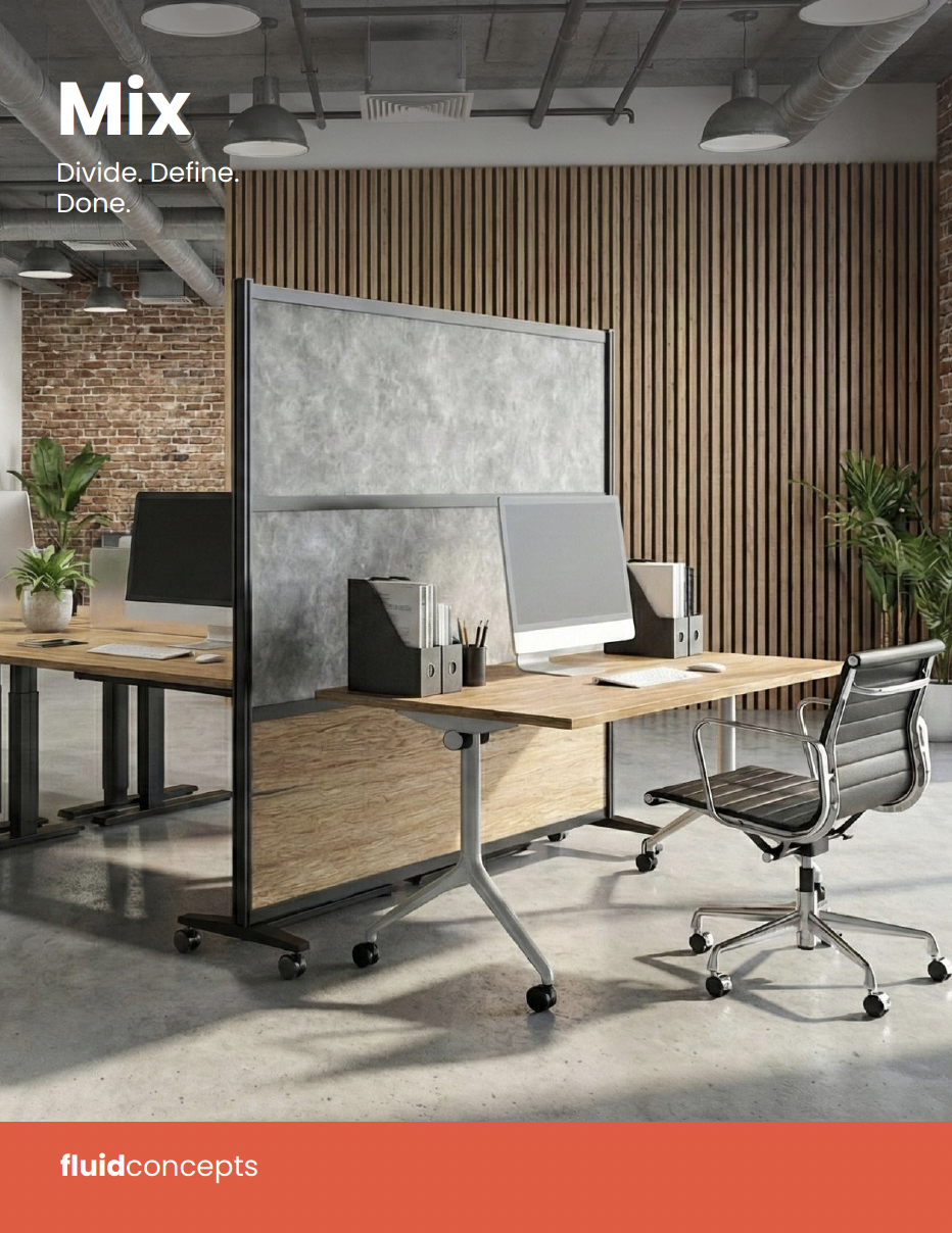 Modern open-plan office with wooden desks, computer monitors, office chairs, green plants, and brick and wood wall decor.