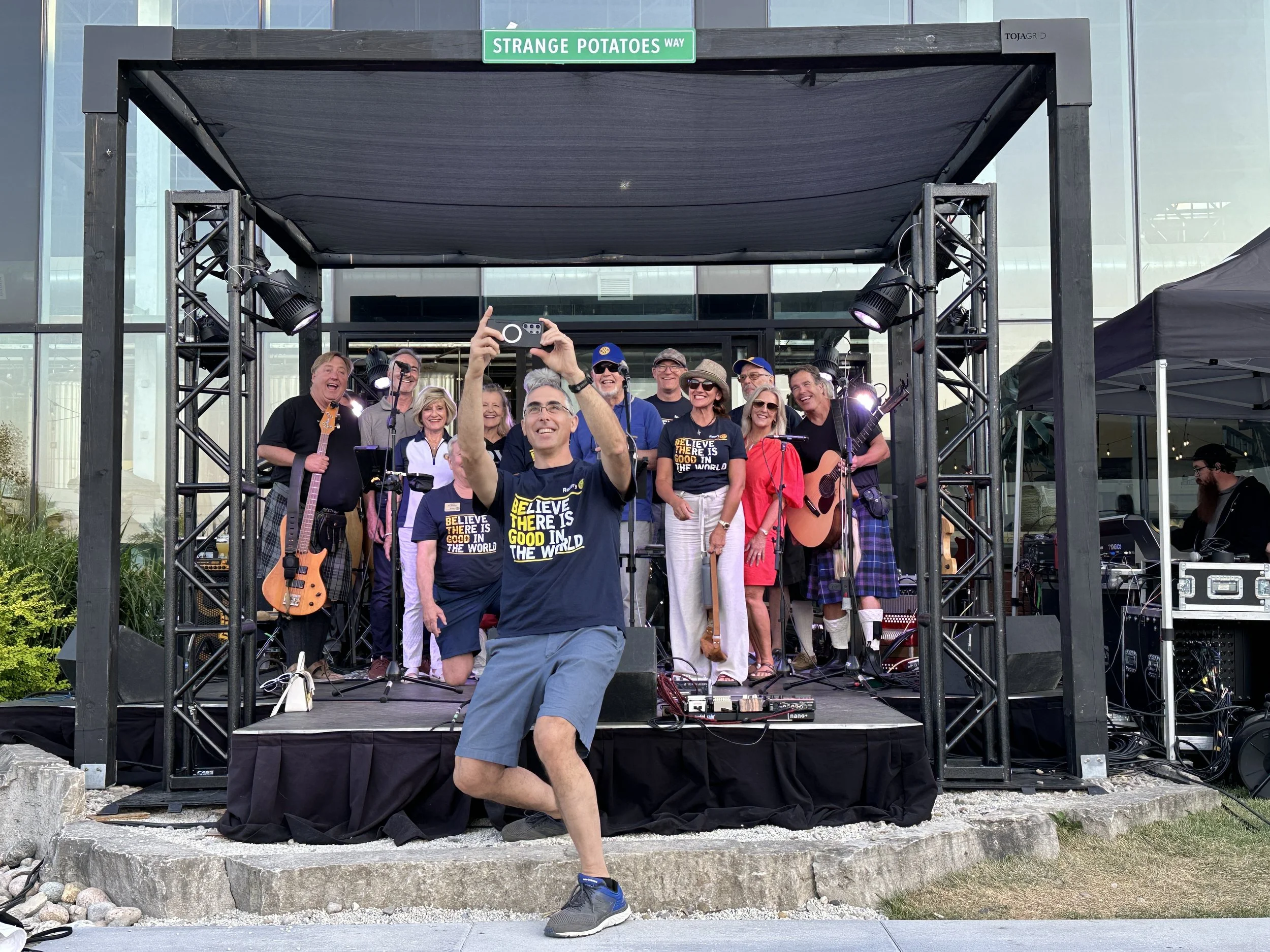 Rotary club of collingwood south georgian bay taking a pictures with the band strange potatoes