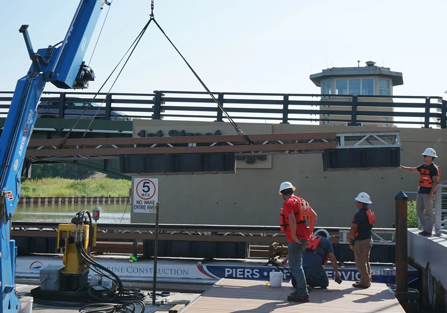   Floating Dock Layout in Progress:  
Multiple floating dock sections are staged and aligned on the water, with layout lines visible for precise spacing and positioning. 