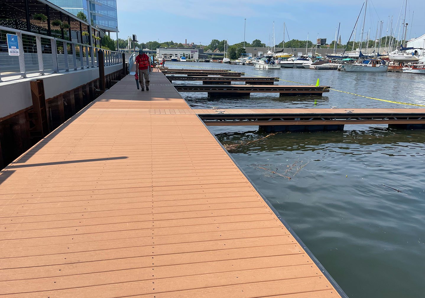   Dock Framing and Deck Installation:  
Crew members work on assembling and securing the structural framing of dock sections prior to installing composite decking materials. 
