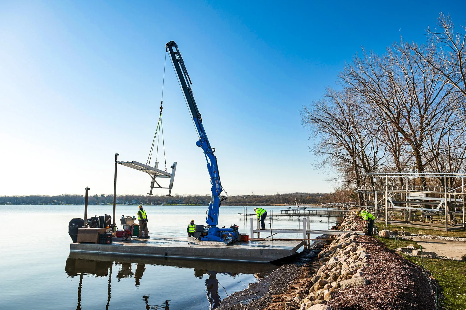 Summerset Marine Construction crews installing a Lifetime pier system along a Wisconsin shoreline ahead of summer lake season.