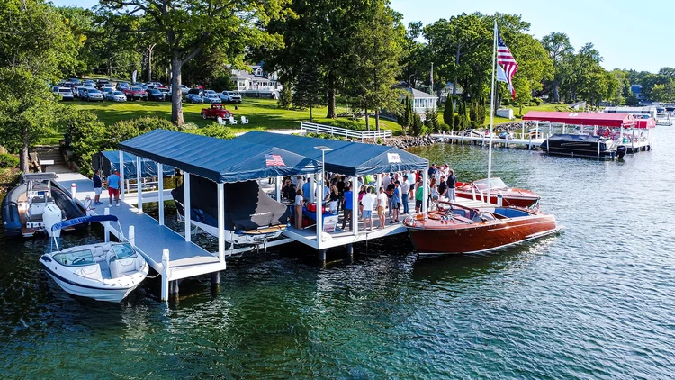 Modern Wisconsin waterfront setup featuring a Lifetime pier system, boat lifts, and lakeside entertaining space.