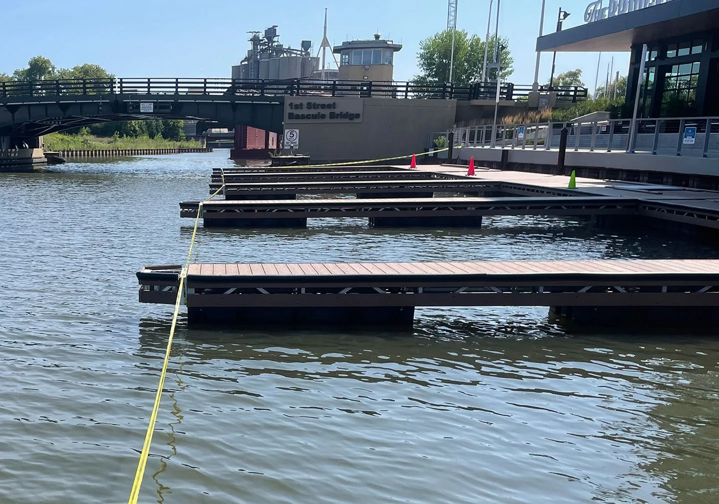   Floating Dock Layout in Progress:  
Multiple floating dock sections are staged and aligned on the water, with layout lines visible for precise spacing and positioning. 