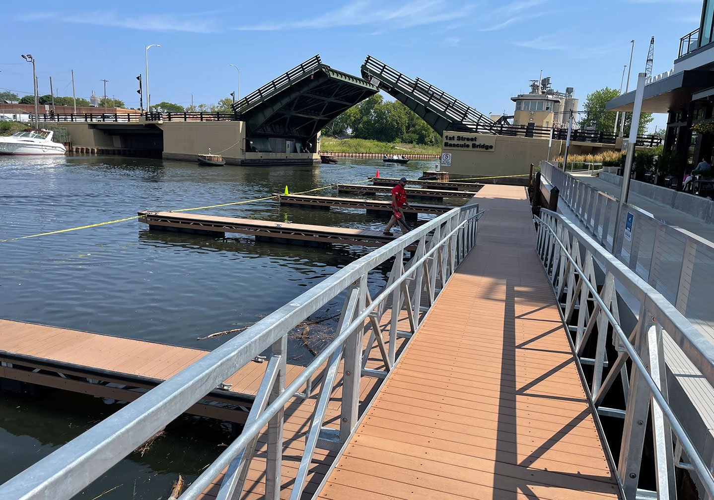   Completed Dock Walkway Installation:  
A finished composite dock walkway extends over the water, connecting to multiple slips and showcasing the completed marina system. 