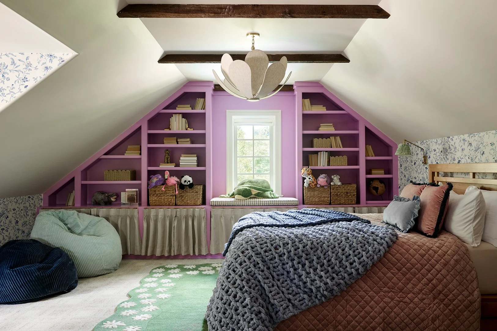 tween bedroom on main line philadelphia with purple built in shelves, floral wallpaper, floral rug, floral chandelier, and reading nook