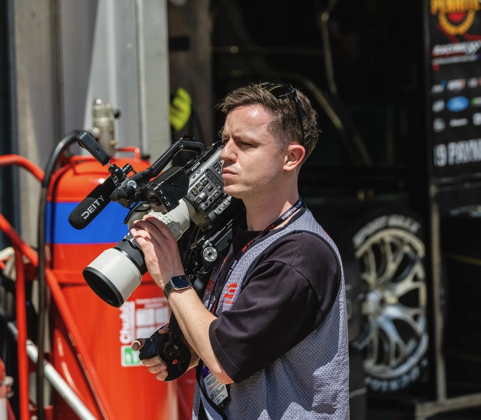 Brad filming at the Supercars, shouldering a Sony FX6 with a long lens