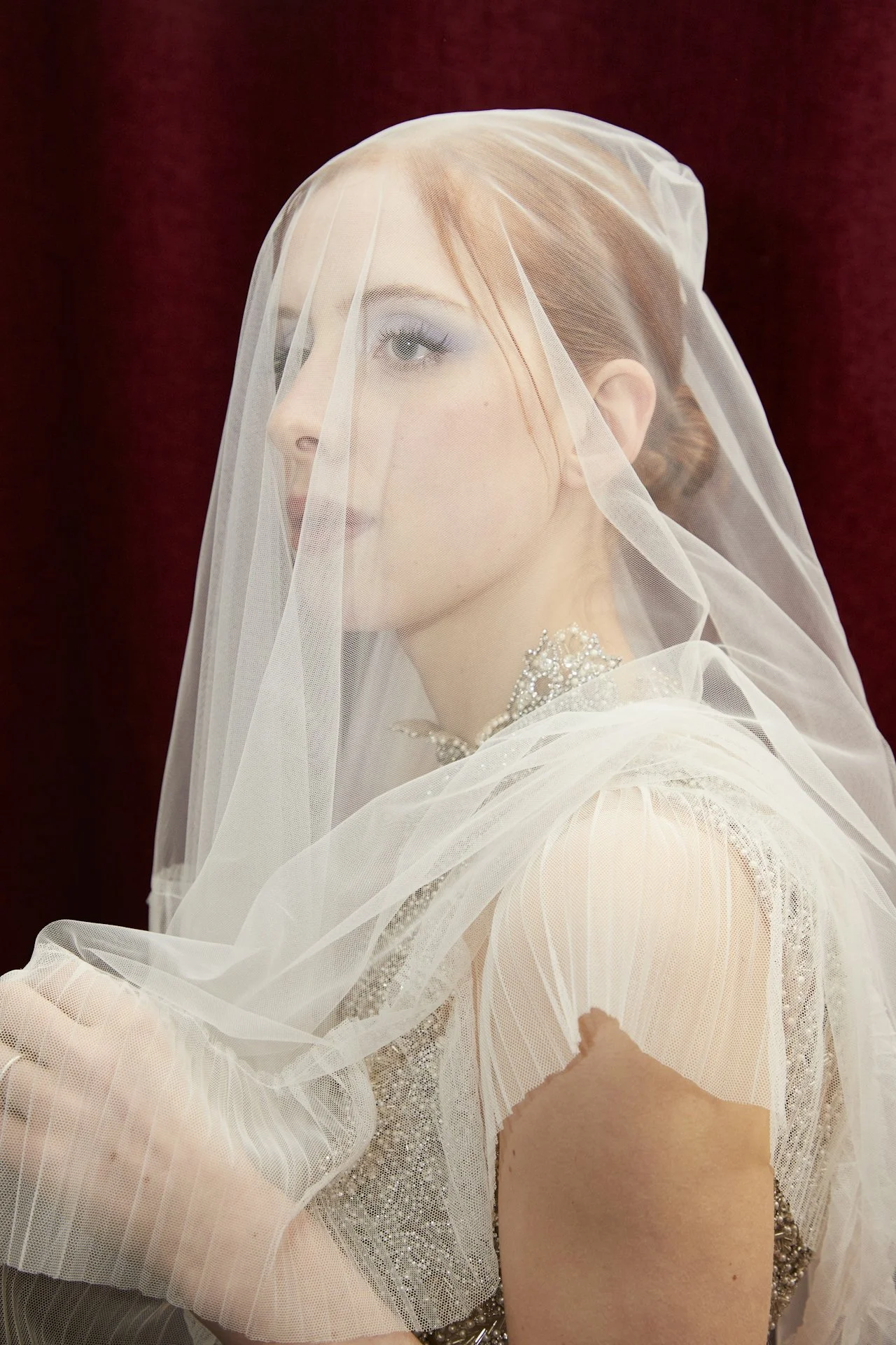 JCI student applying makeup to a model during a hands-on session in the media makeup program.