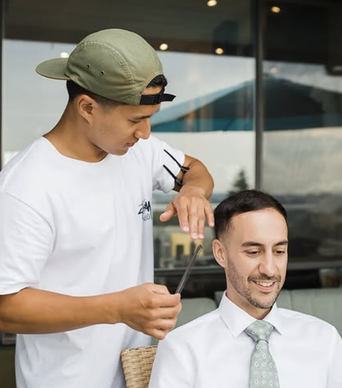 JCI student applying makeup to a model during a hands-on session in the media makeup program.
