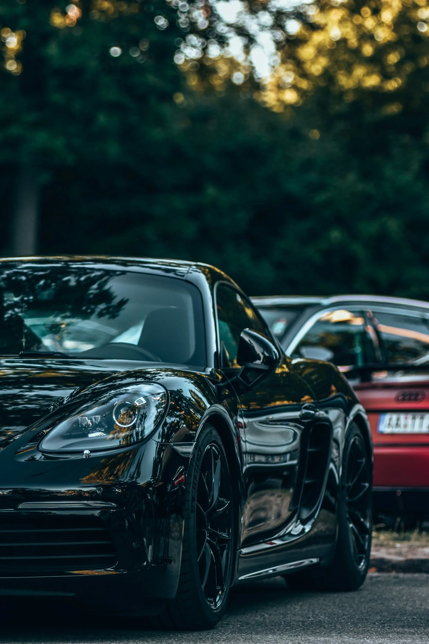 A freshly detailed vehicles parked outside a modern building — showcasing the premium results of our mobile car detailing service. Book today for a spotless finish wherever your car is parked.